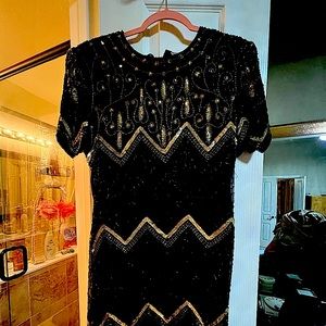 Beautiful just above the knee black cocktail dress with gold sequins.
